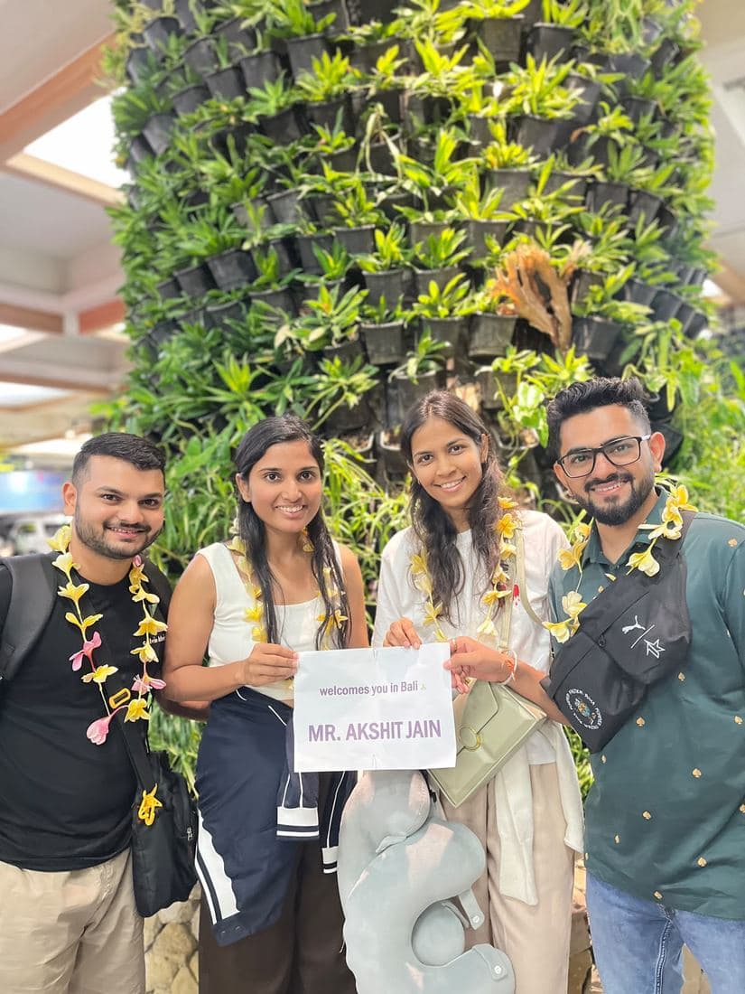 Friends travelling with Trripah, welcomed at Bali airport with flower garlands