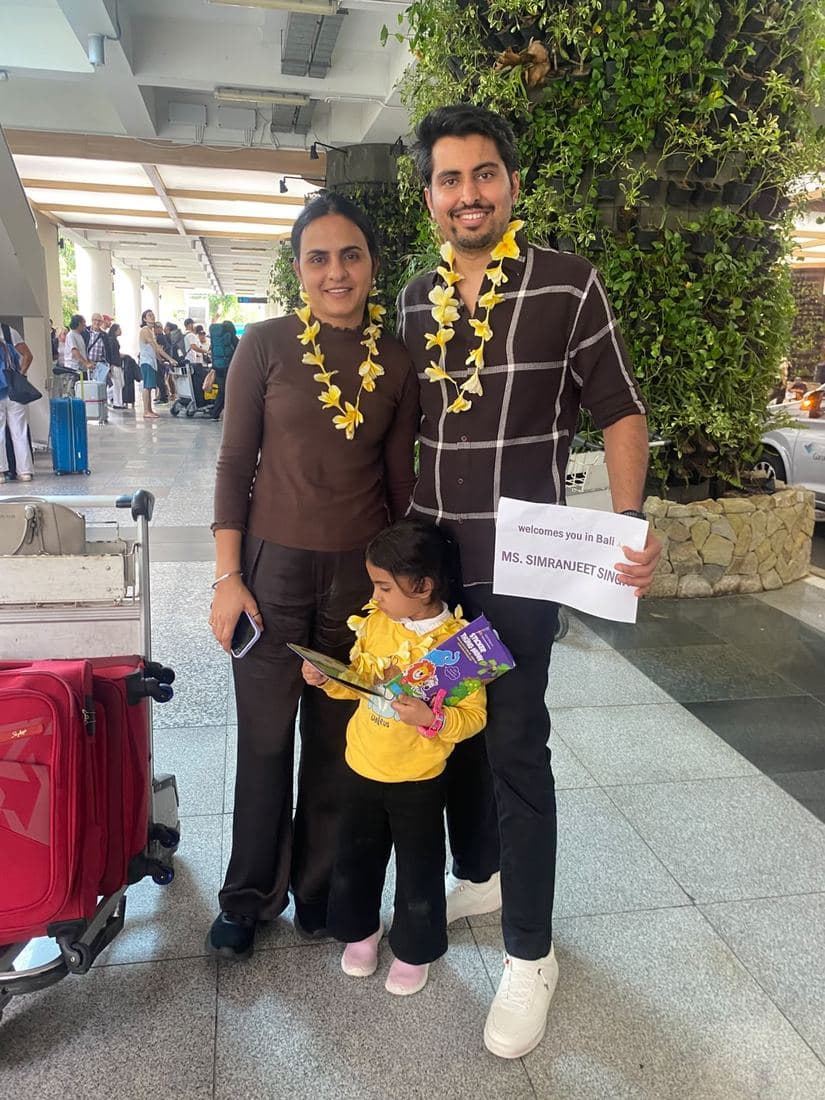 A family travelling with Trripah, welcomed at Bali airport with flower garlands